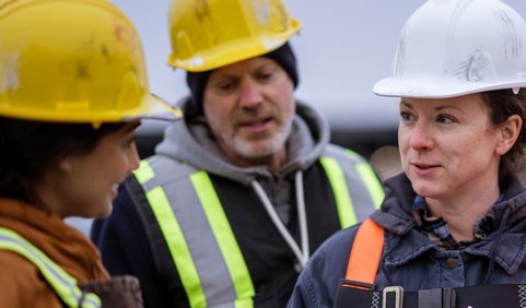 Construction workers discussing safety procedures on site