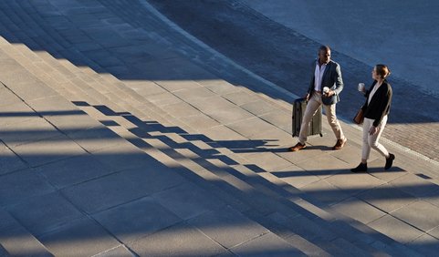 Two business professionals walking outdoors.