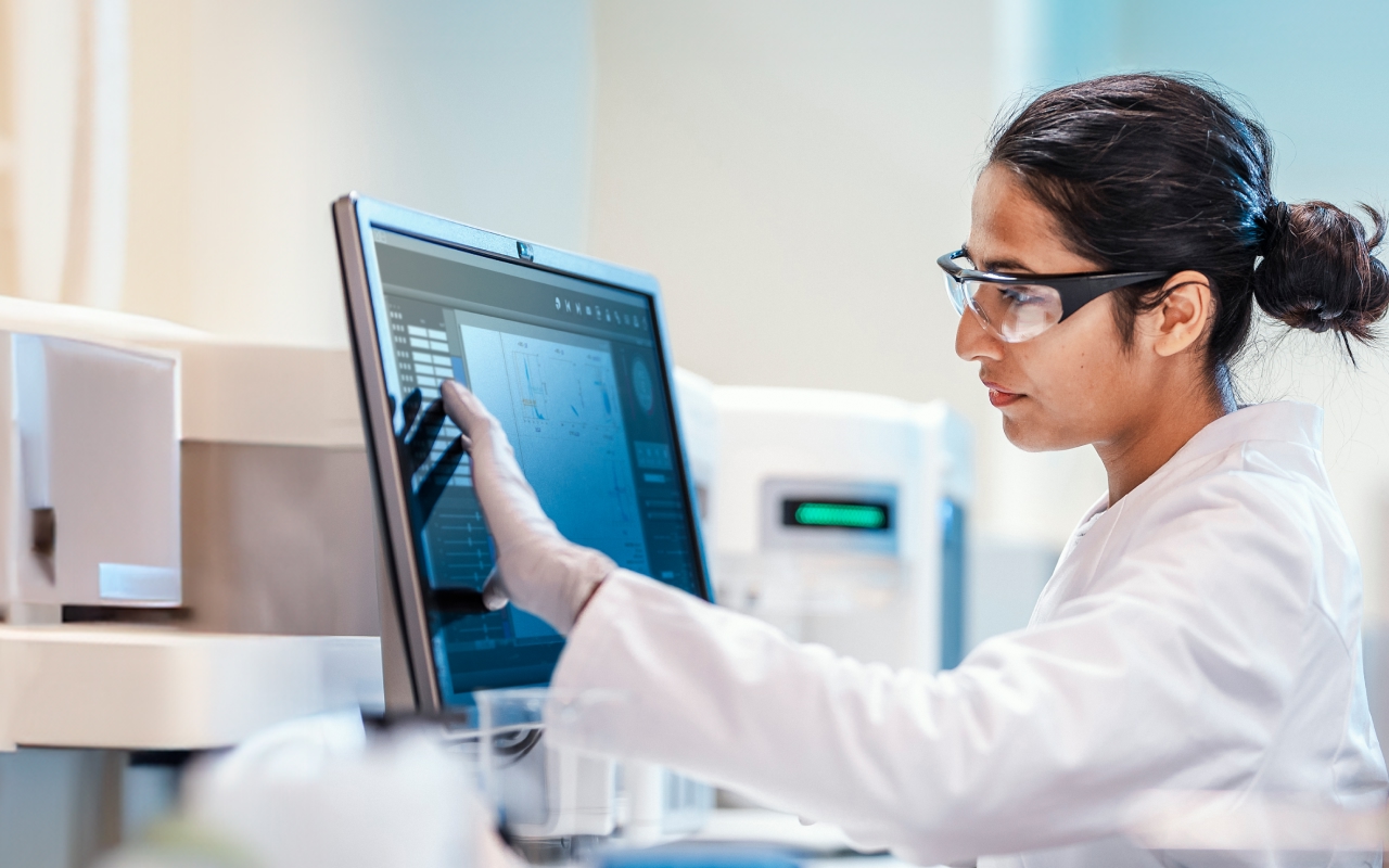 A person in a hazardous materials area looking at a computer screen.